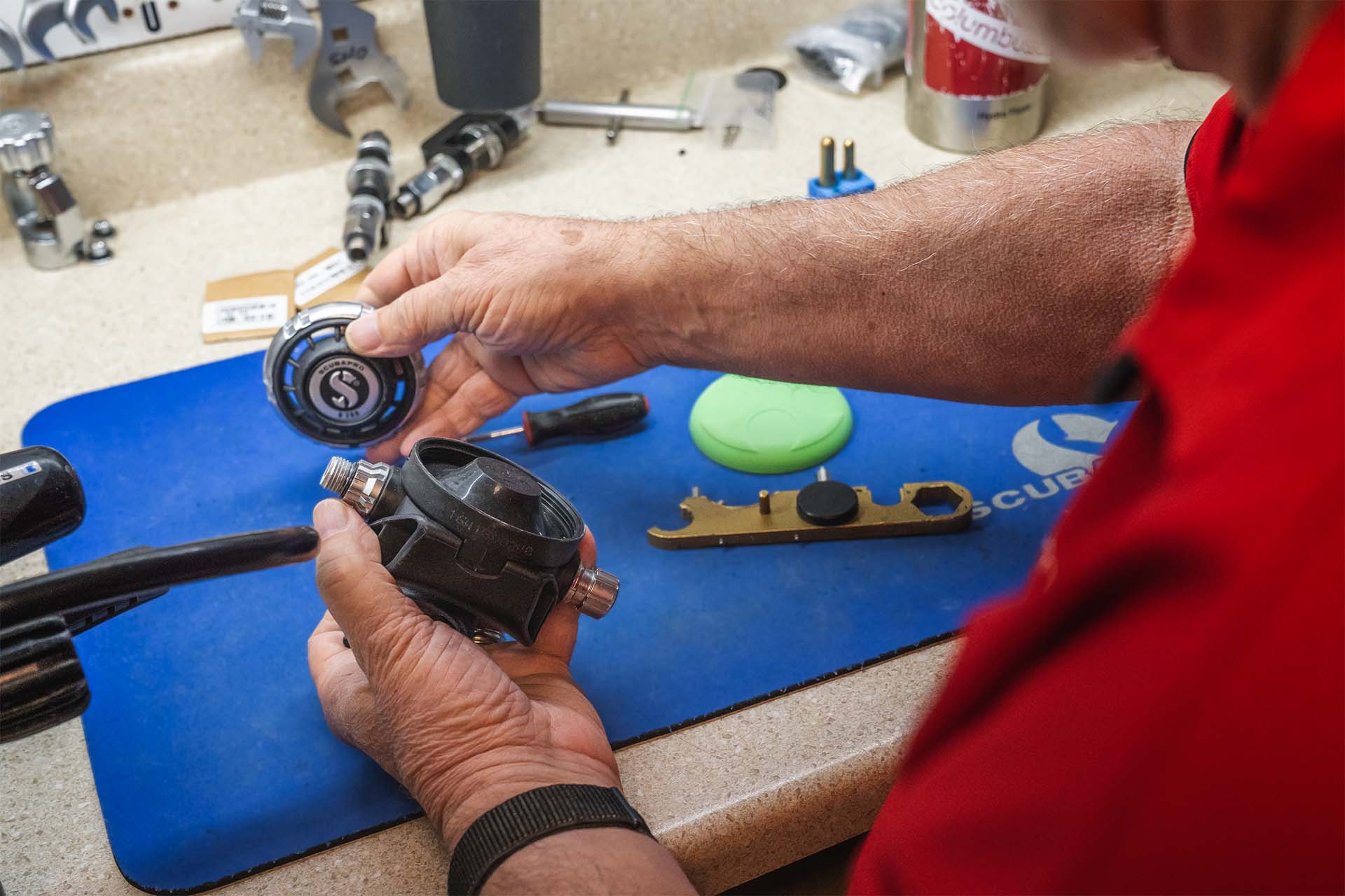 Professional regulator rebuild in progress with technician disassembling components on service mat