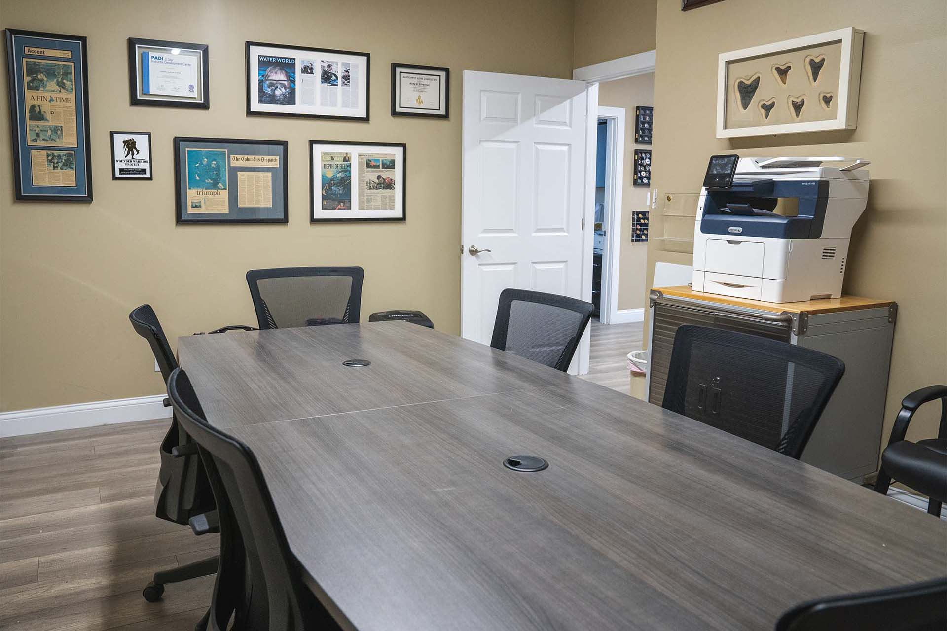 Dive training classroom at Columbus Scuba with table seating and dive-themed wall displays