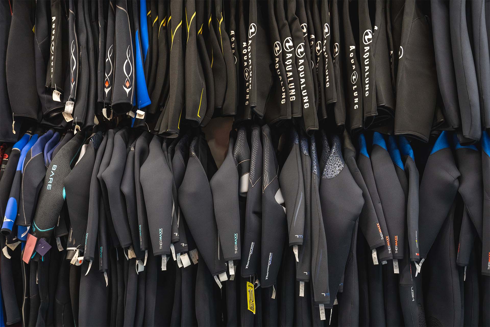 Columbus Scuba warehouse inventory showing organized wetsuit stock