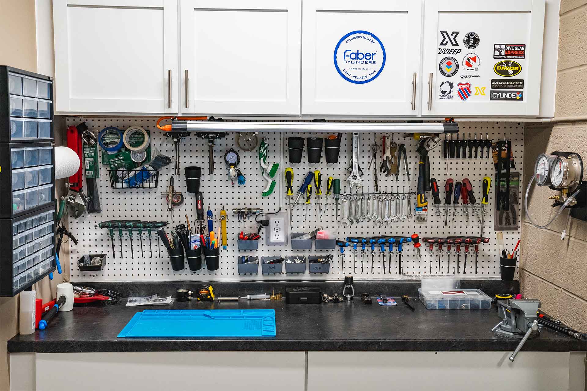 Service Bay 3 organized workbench with extensive tools and storage at Columbus Scuba service bay