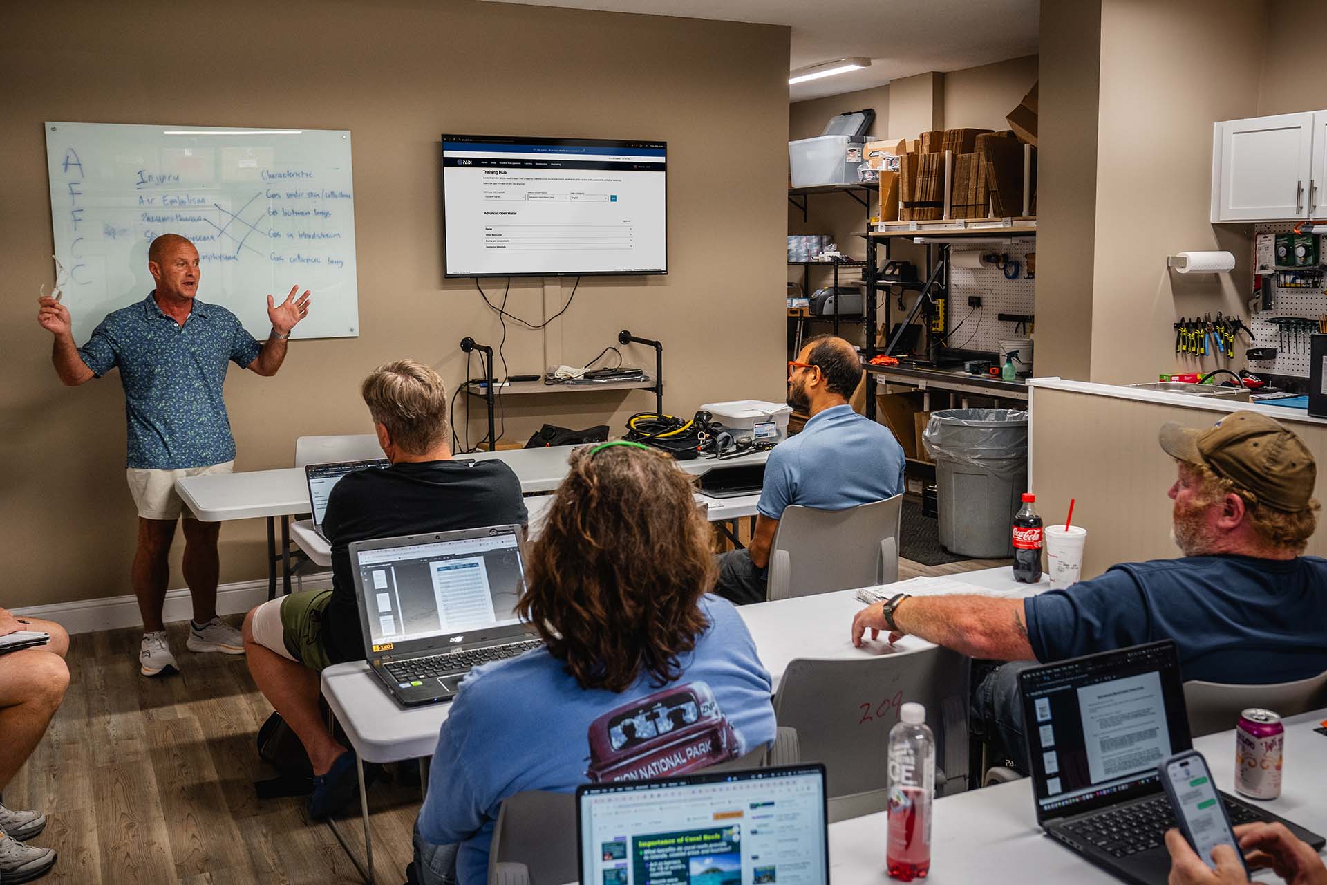 PADI Course Director leading an Instructor Development Course classroom session with IDC candidates reviewing dive theory and injury prevention at Columbus Scuba Ohio